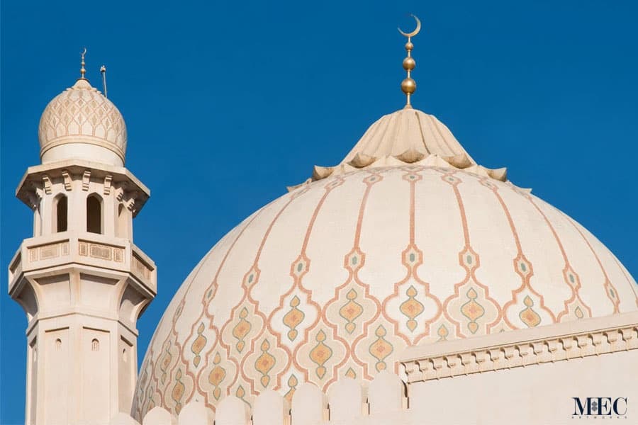 Moroccan trellis custom mosaic pattern in neutral colors on a Mosque dome. The beige and cream accented with a hint of yellow. Sultan Qaboos Grand Mosque