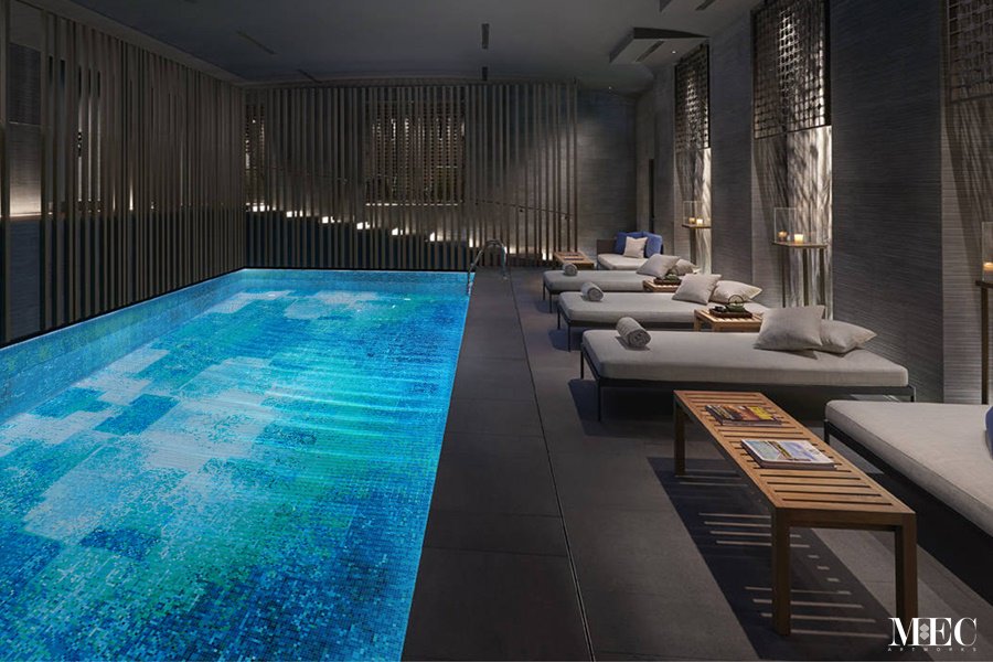 Thousands of glass tiles glisten in the light and create a mesmerizing effect in the abstract mosaic swimming pool by MEC.