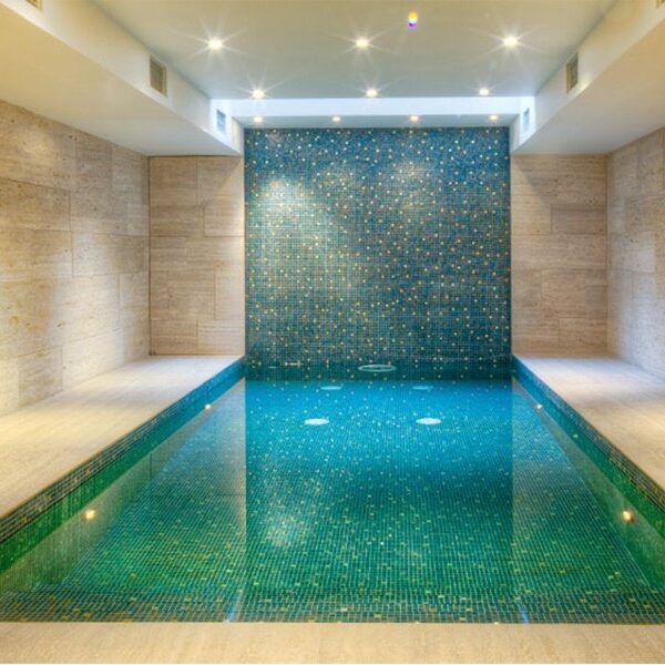 Swimming pool interior and cascade wall cladded with handcrafted mosaic brilliance by MEC.