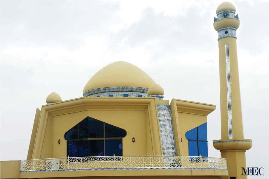 A mosque minaret and exterior walls cladded with custom glass mosaic Moroccan zellige tile pattern. Custom handcrafted by MEC.