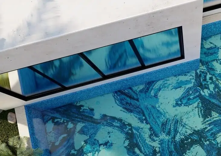 swimming pool with artistic blue mosaic tiles and natural skylight. Modern home design.