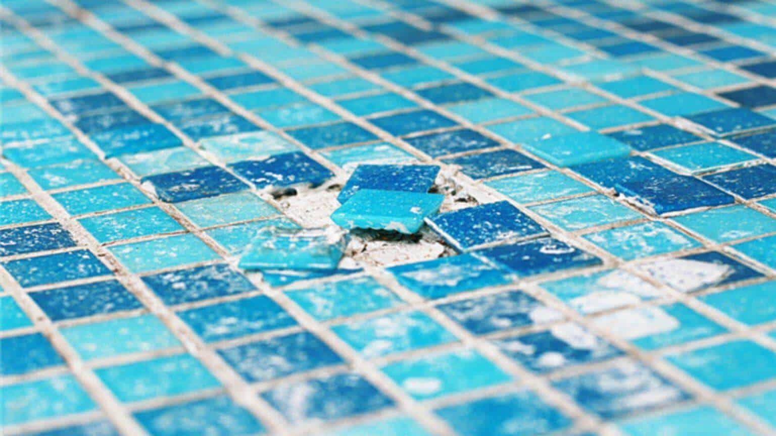 A close-up view of broken mosaic tile in a substandard during installation 