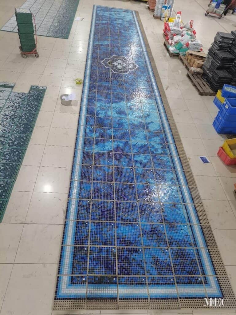 abstract pixl pool mosaic with centre motif and gradient border workshop production completed