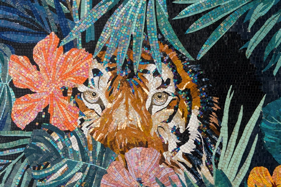 Tiger mosaic with piercing eyes, surrounded by tropical leaves and hibiscus flowers in vibrant glass tiles.