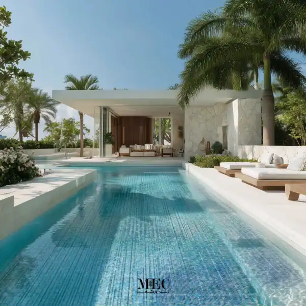 Luxury swimming pool with blue mosaic tile design, modern villa layout, sun loungers, and tropical palm surroundings.