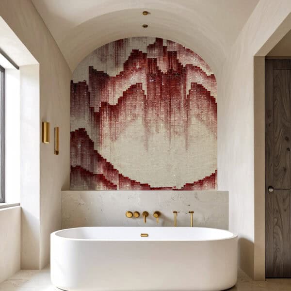 Crimson Mirage Mosaic Modern bathroom with a freestanding white bathtub, gold fixtures, and an arched mosaic wall featuring a cascading pattern in shades of crimson, burgundy, and beige.