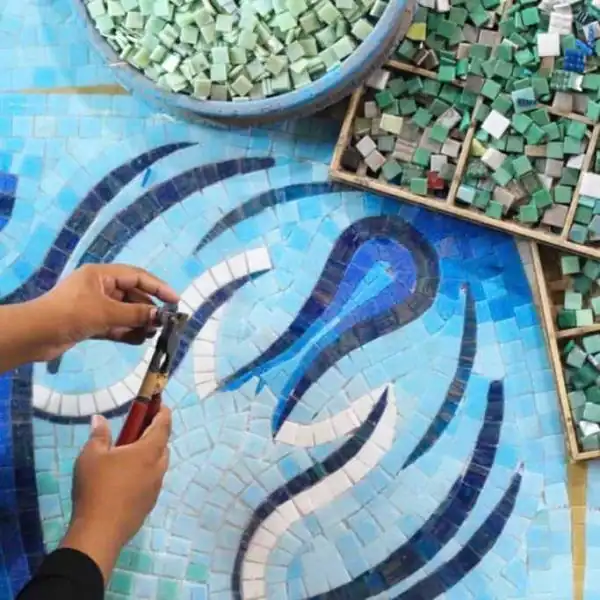 Mosaic artists working on a custom piece