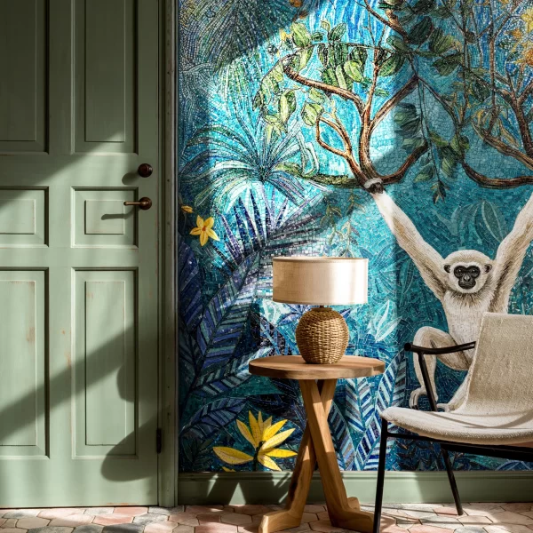 Monkey in Paradise Mosaic Wall Blue jungle mosaic wall with tropical leaves, branches, yellow flowers, and a white monkey design in detailed handcrafted tile artwork.