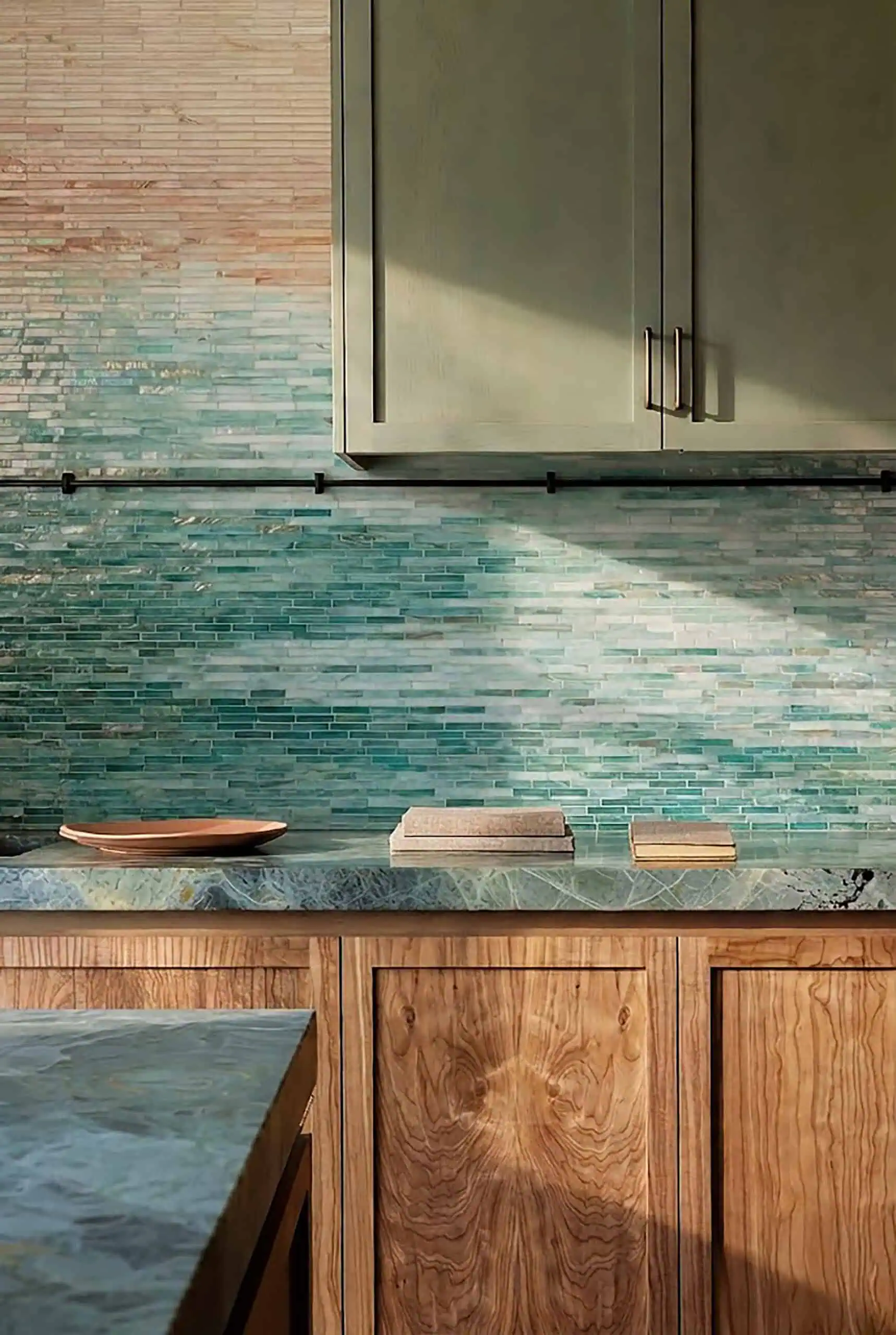 Coastal ombre linear mosaic backsplash with slim horizontal mosaic tiles fading from beige to aqua and deep teal, modern kitchen feature wall design.