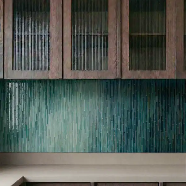 Verdant Depth Ombre Linear Mosaic Verdant Depth Ombre Linear Mosaic used as a modern kitchen backsplash with bronze fixtures and dark wood cabinetry.